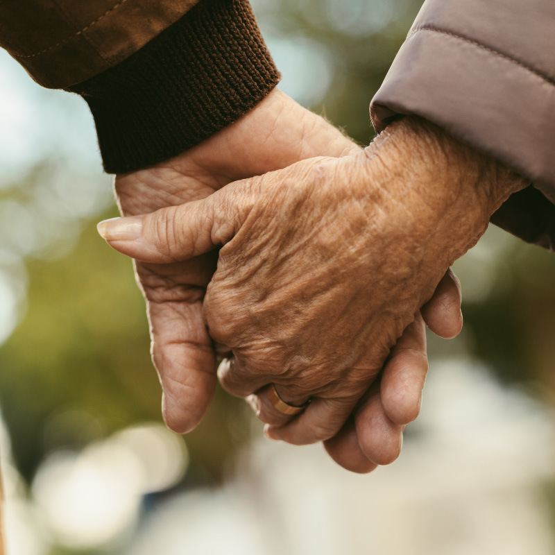 old couple holding hands.