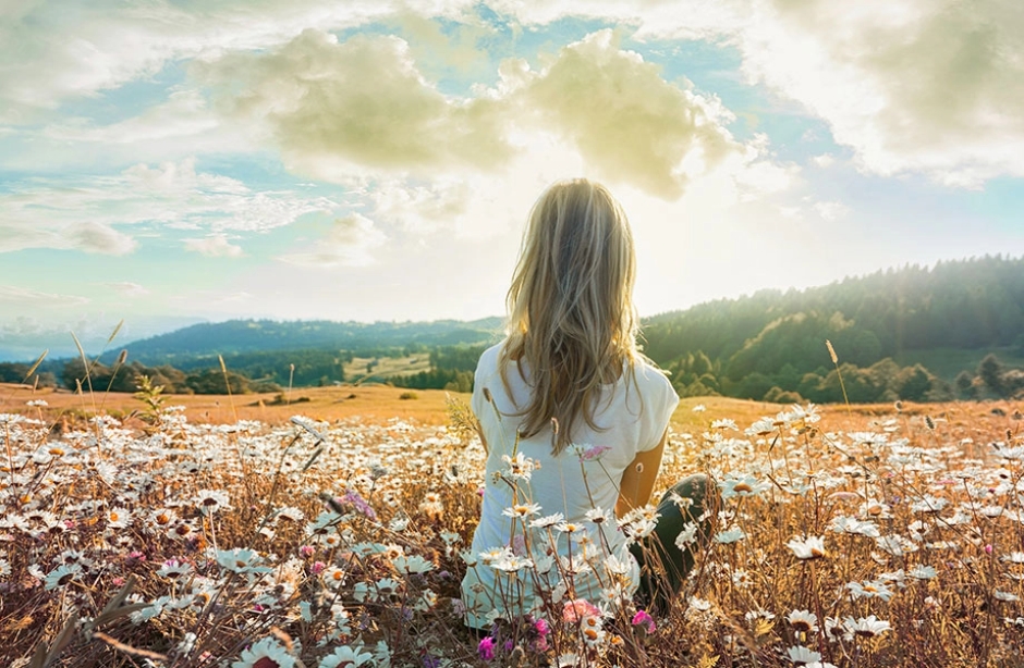 woman sitting in flowers.